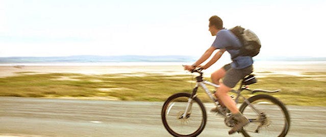 Cyclist cycling along the coast