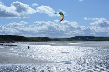Windsurfers over the beach