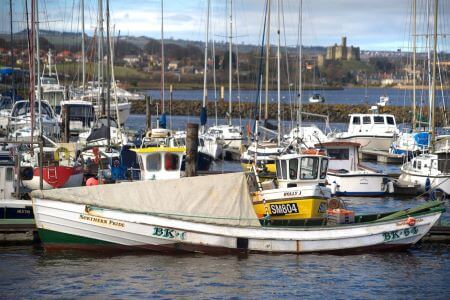 View over Amble marina to Warkworth Castle