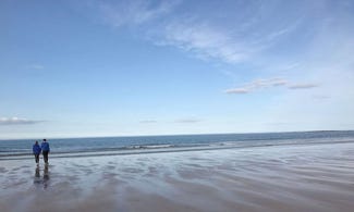 couple walking on sandy beach