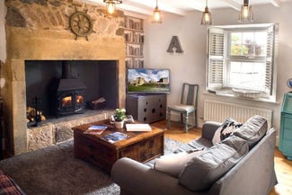 cosy living room with lit woodburner