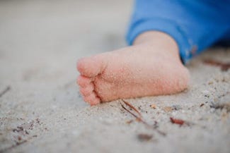 babies feet in the sand