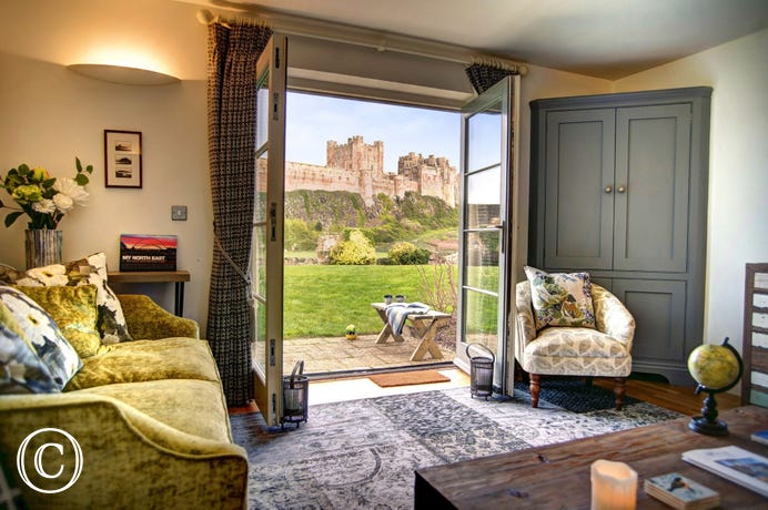 Living room with doors to garden and castle views